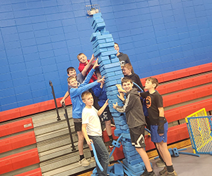Group of students building a tower in the gym
